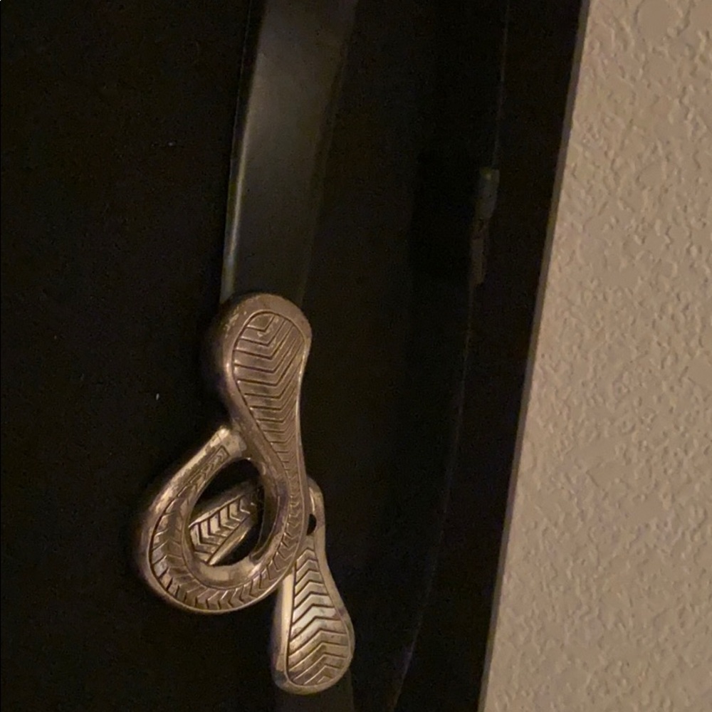 Black belt with a silver colored buckle